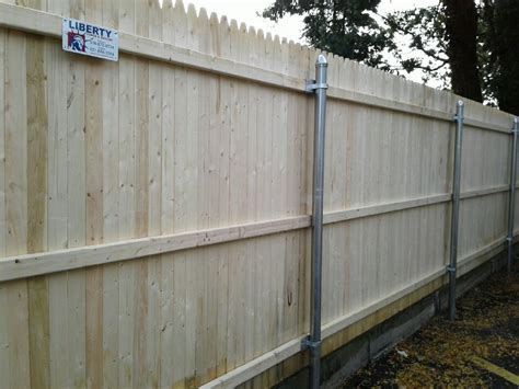 stockade fence with metal posts